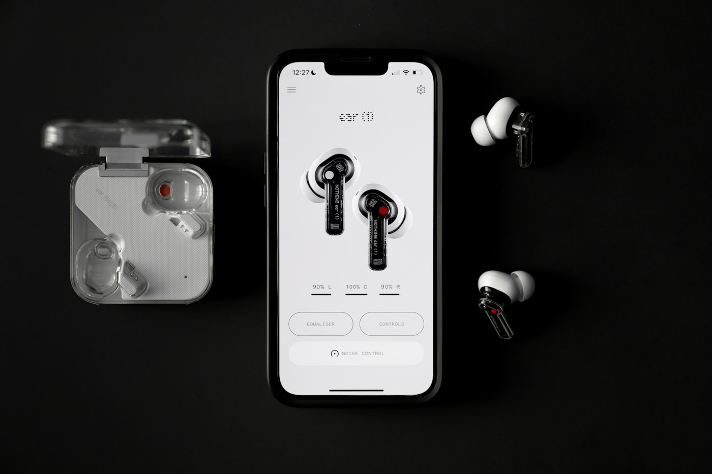 Phone and earbuds for downloading a SoundCloud playlist on mobile